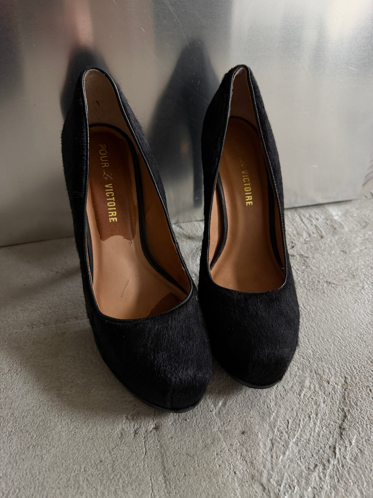 Black leather heels with a sleek, elegant silhouette.
