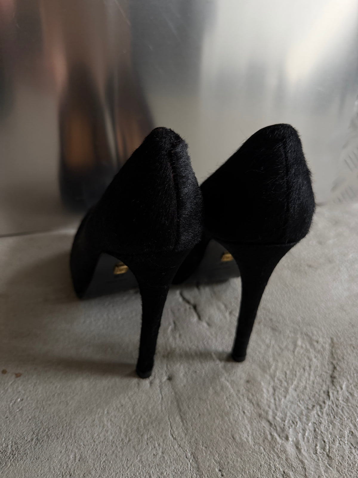 Black leather heels with a sleek, elegant silhouette.
