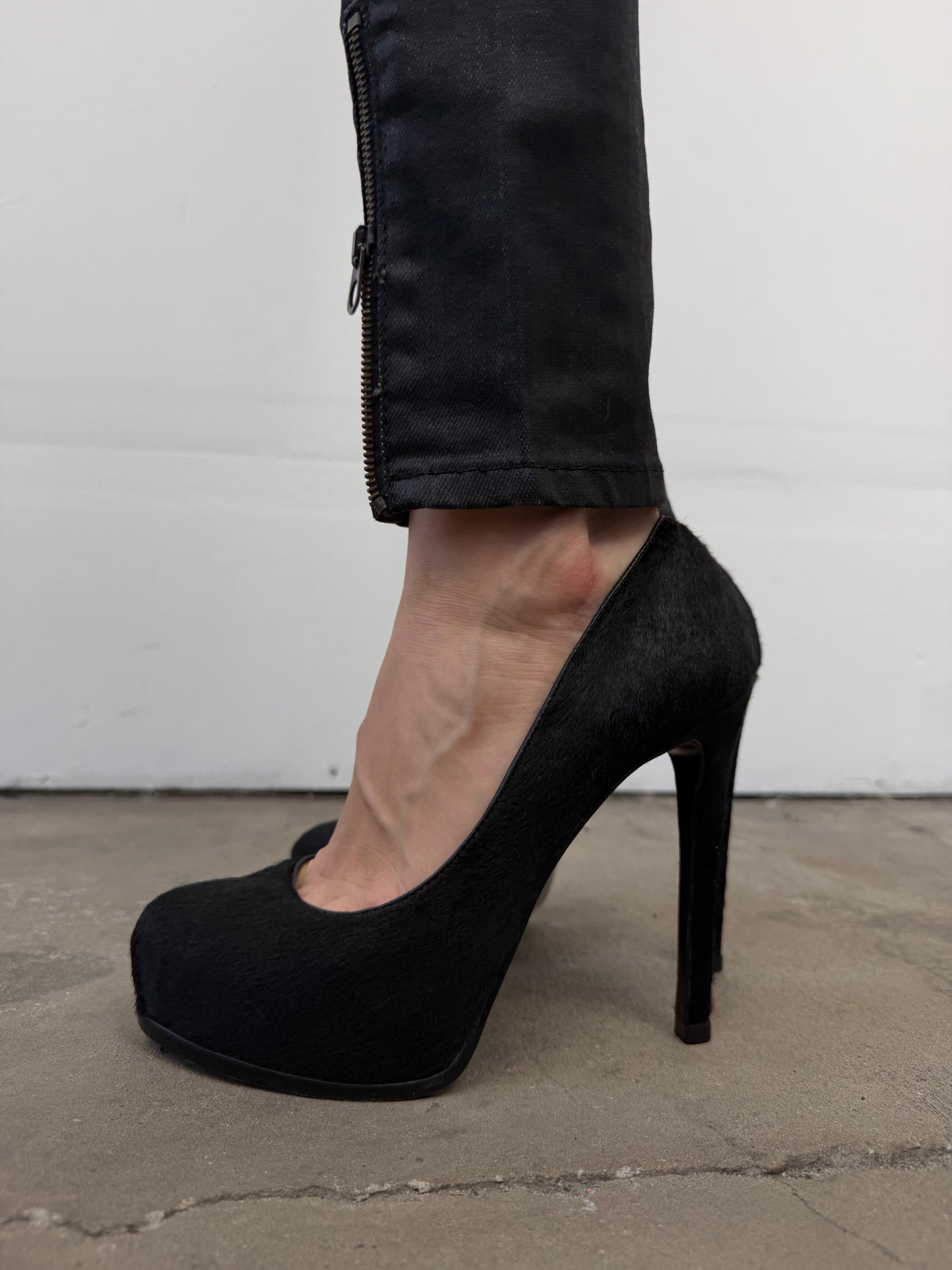 Black leather heels with a sleek, elegant silhouette.