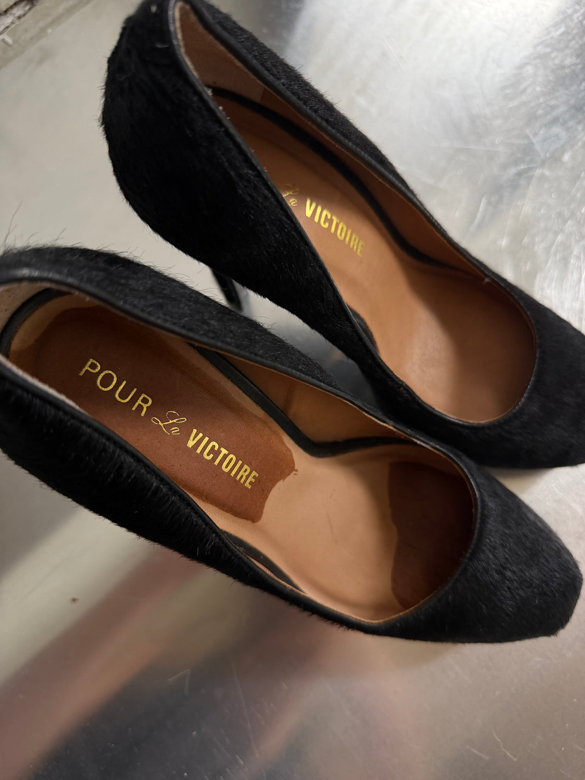 Black leather heels with a sleek, elegant silhouette.