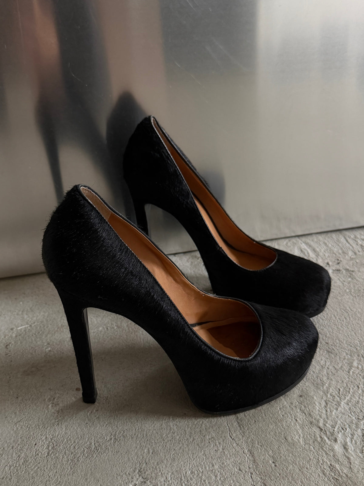 Black leather heels with a sleek, elegant silhouette.