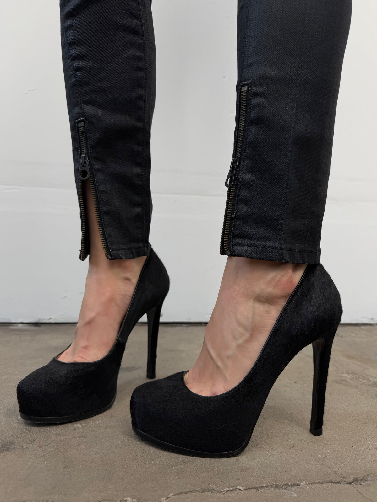 Black leather heels with a sleek, elegant silhouette.