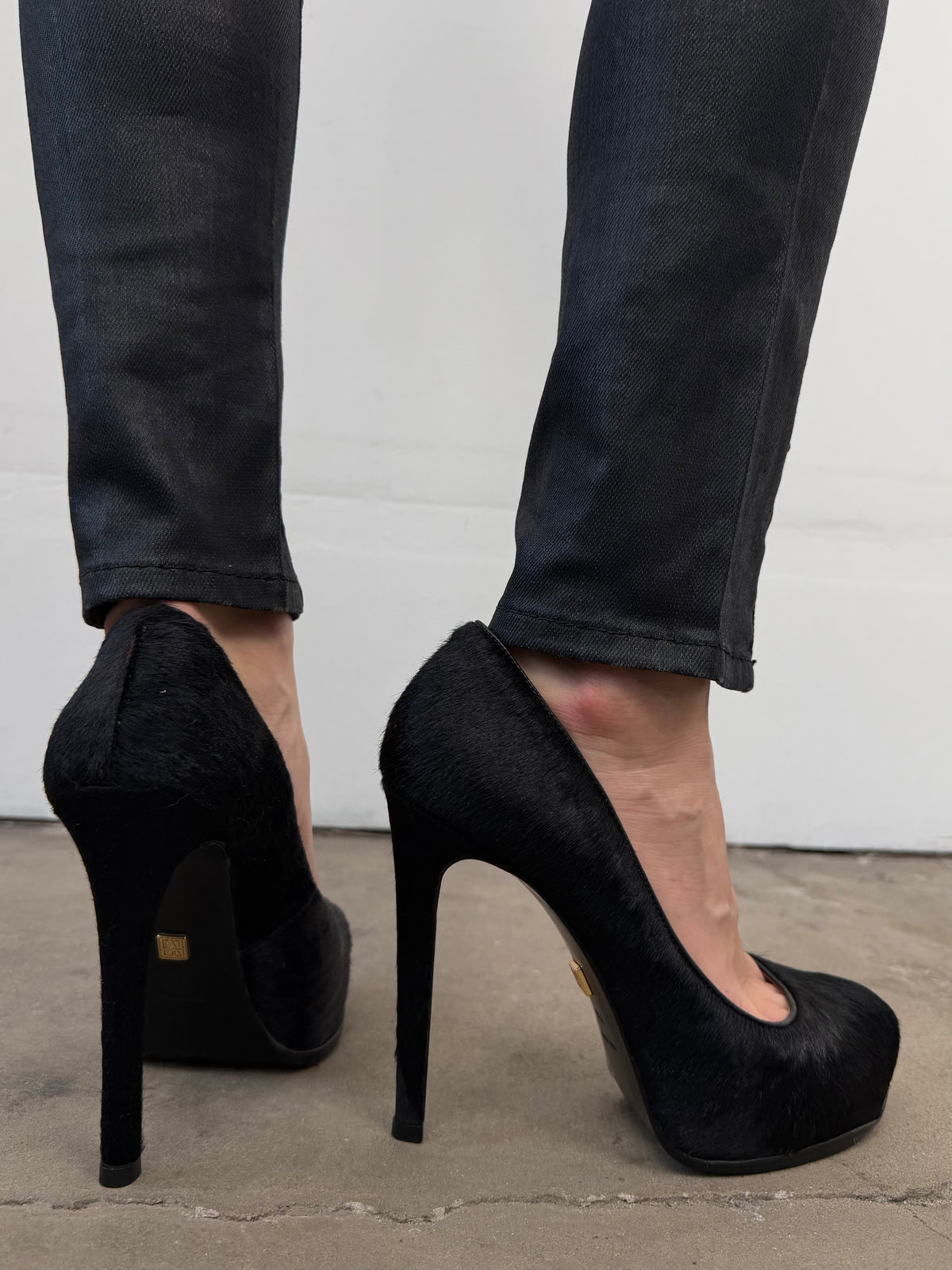 Black leather heels with a sleek, elegant silhouette.