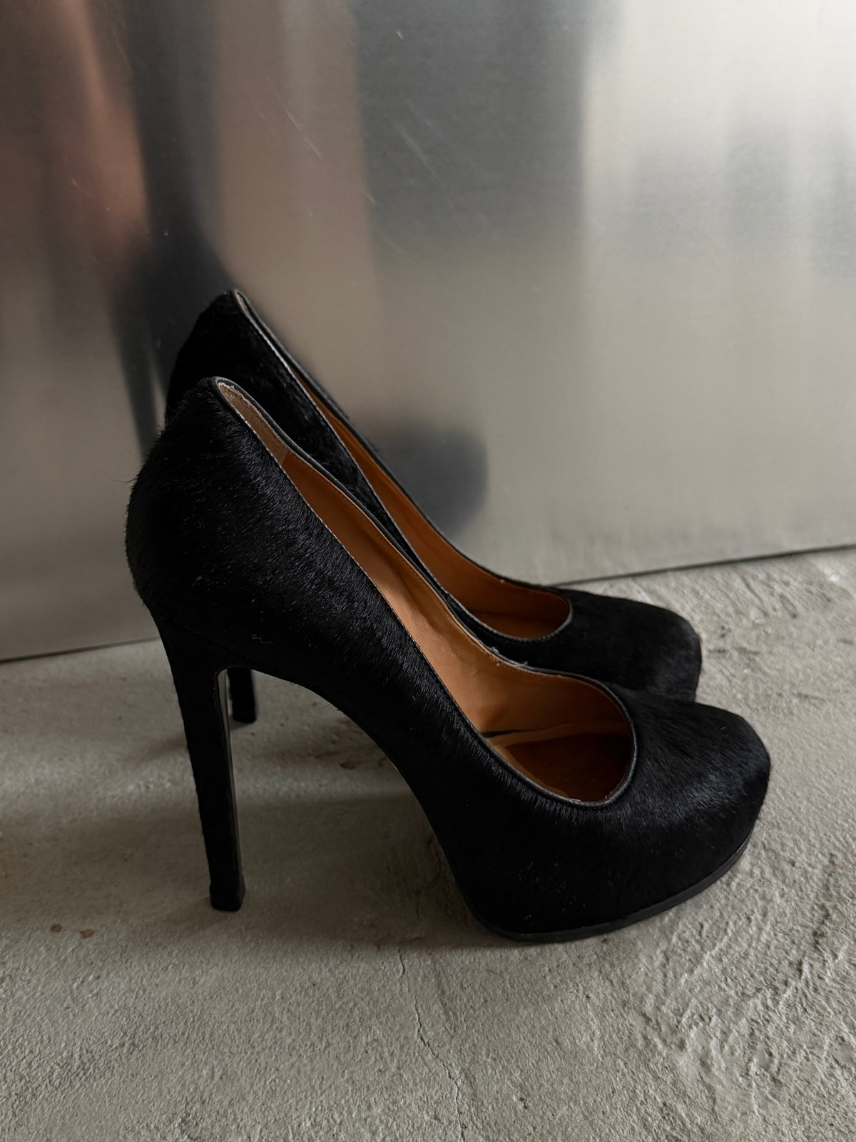 Black leather heels with a sleek, elegant silhouette.